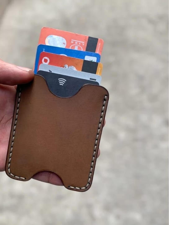 The Maverick Card Sleeve in brown leather, flat lay