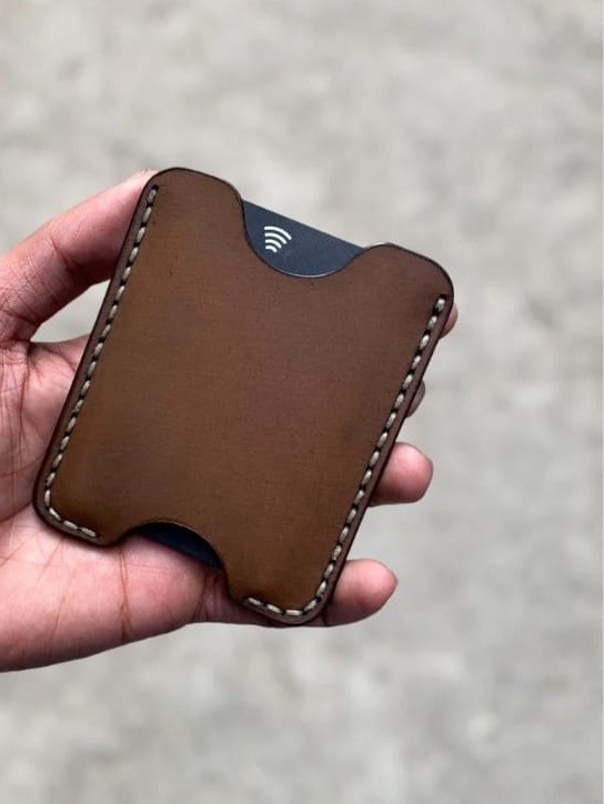 The Maverick Card Sleeve held in hand, showing a contactless card seated in the slot