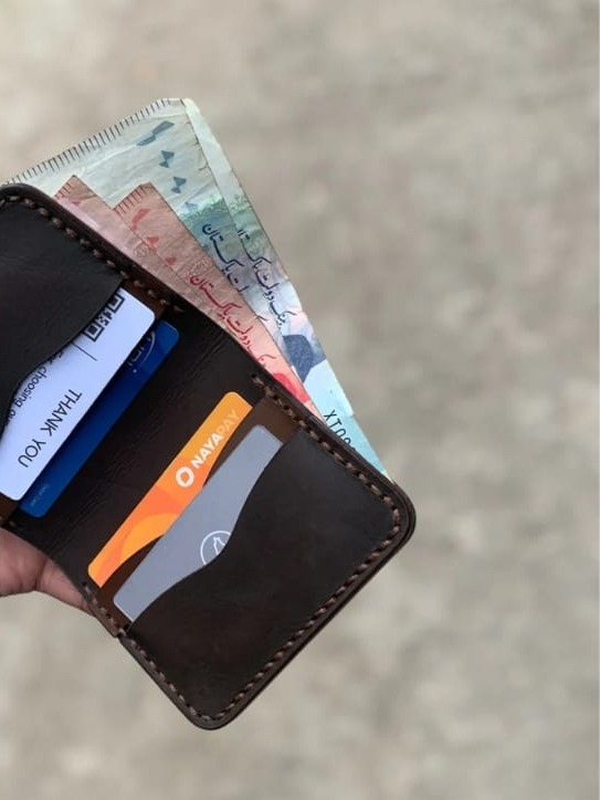 The Rancher Bifold Wallet open, showing card slots and bill compartment