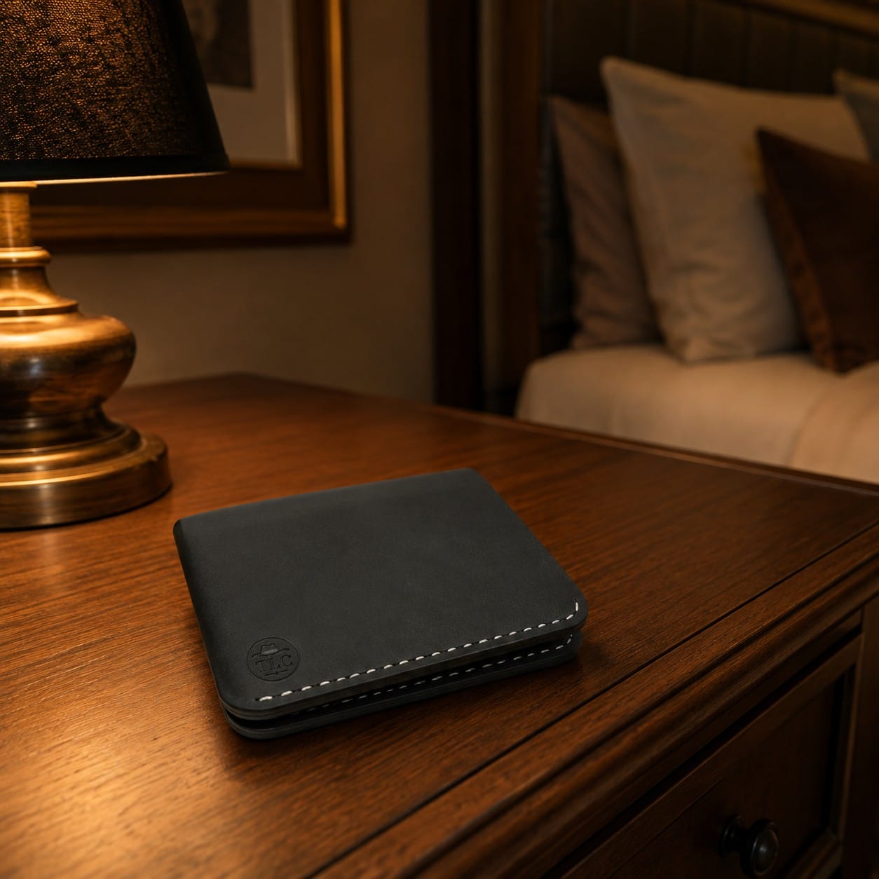 The Heritage Edge Wallet styled on a bedside table